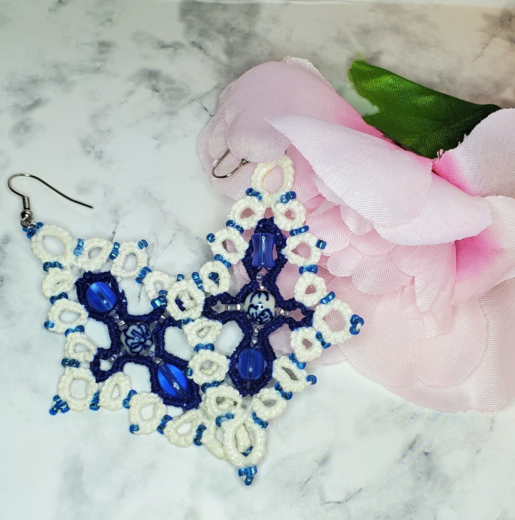 Custom White Blue Earrings Staged with pink fake Flower and white marble background