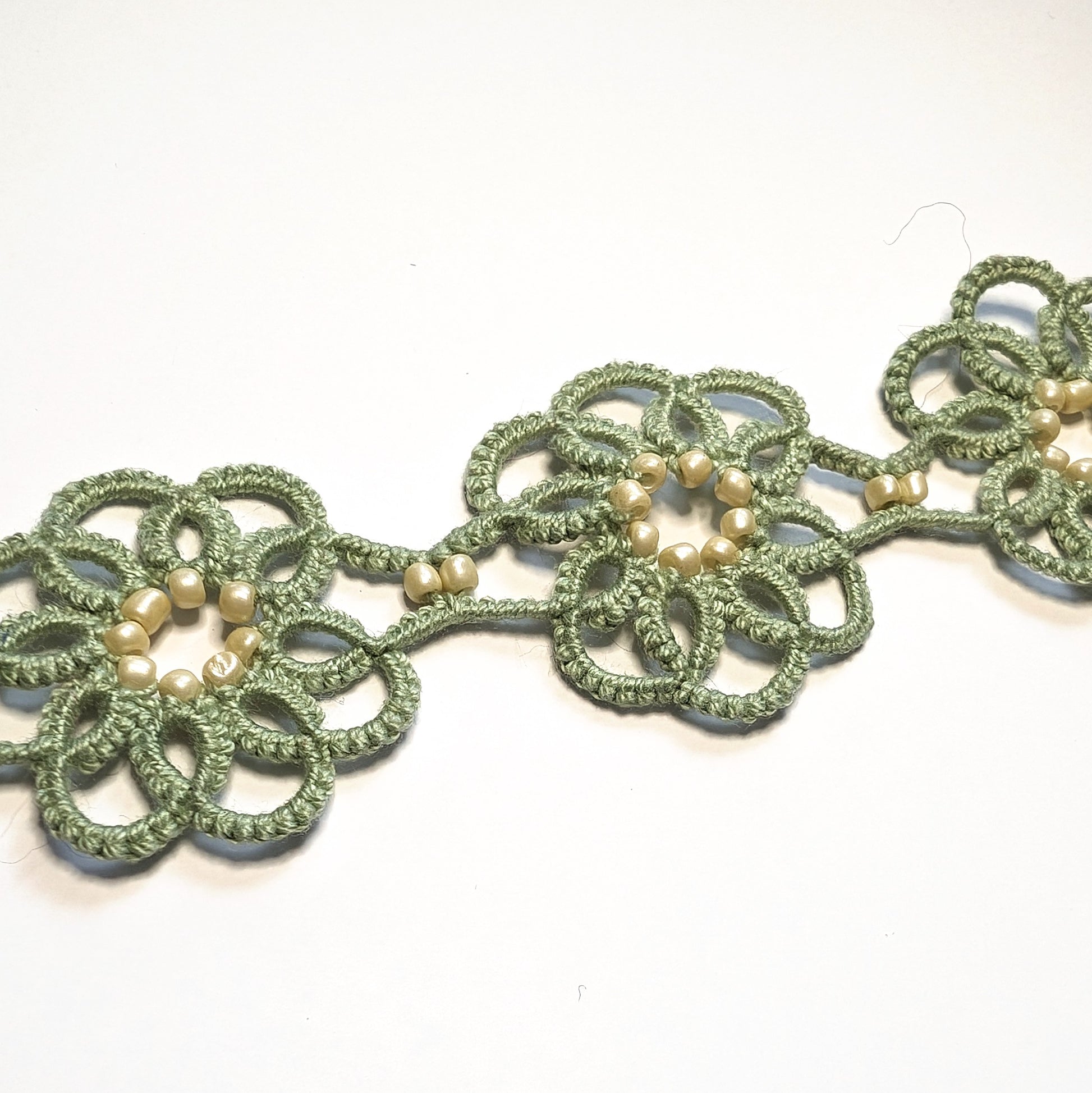 Green Cream Clematis Bracelet on White Background