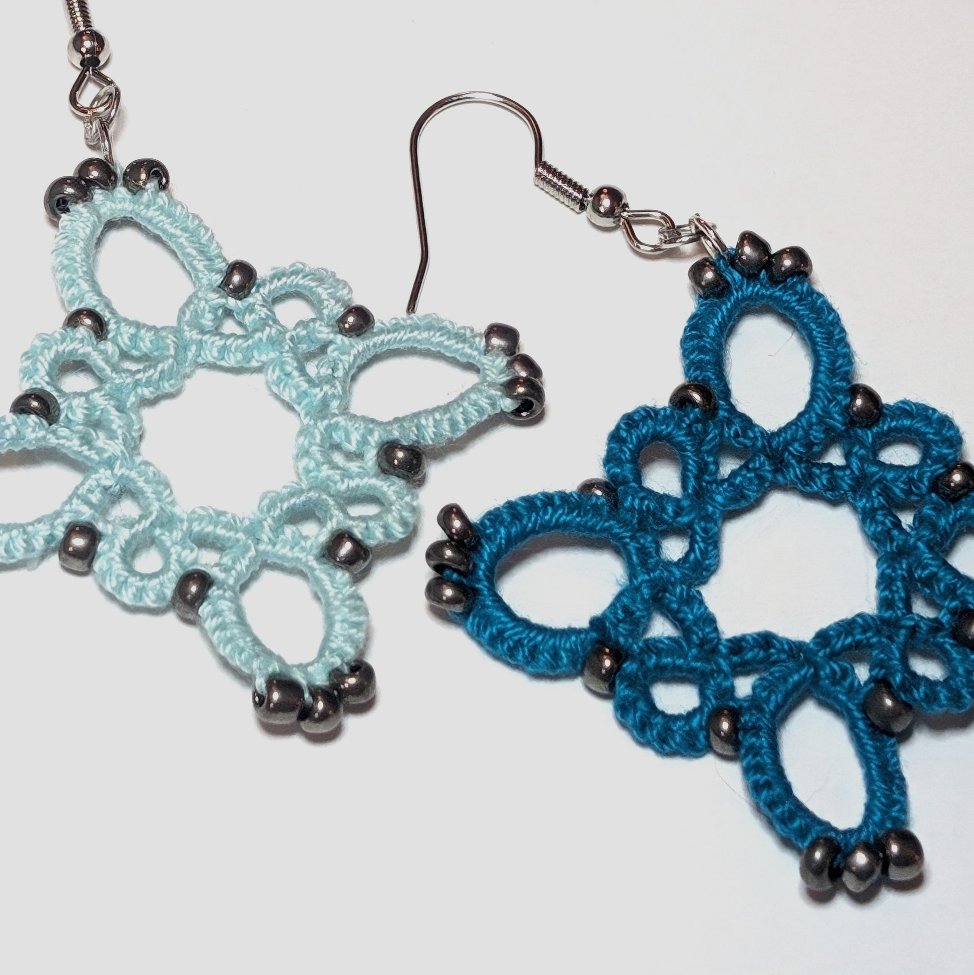 Icy Mint Teal Silver Starburst Earrings Closeup on white background