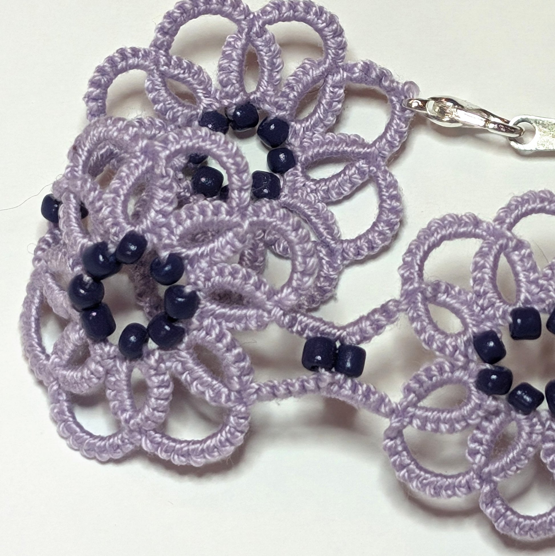 Lilac Dark Purple Clematis Bracelet Closeup on white background