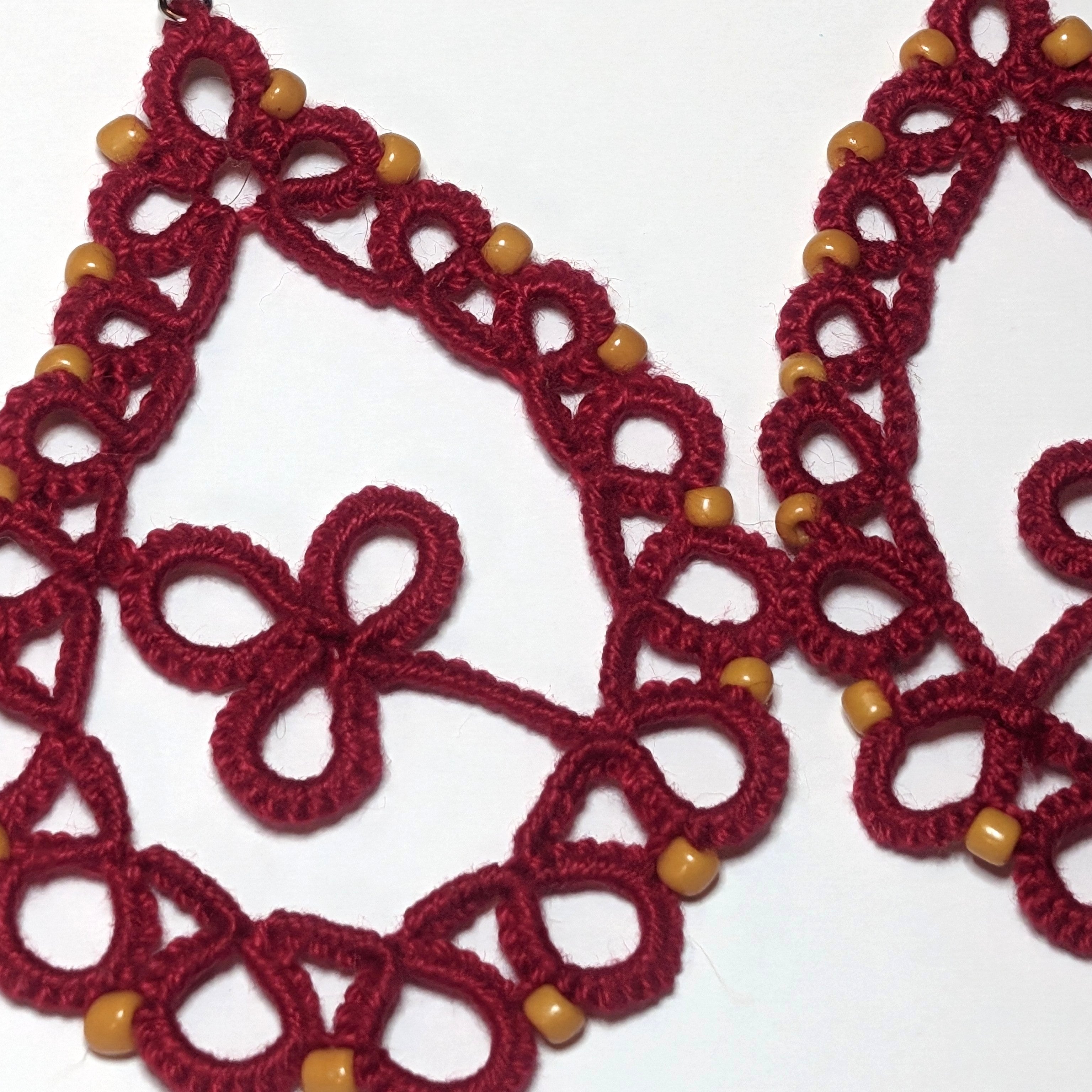 Red Yellow Gold Clover Drop Earrings Closeup on white background