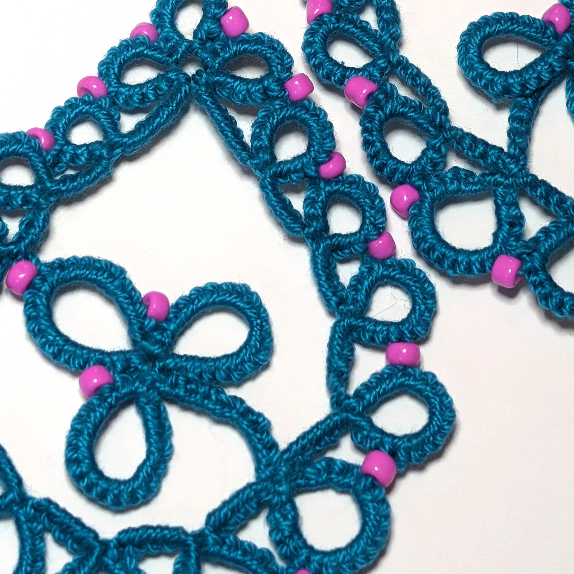 Teal Pink Clover Drop Earrings closeup on white background